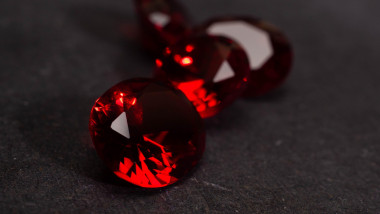 Close up shoot of faceted red diamond like gems. Shoot on a black background