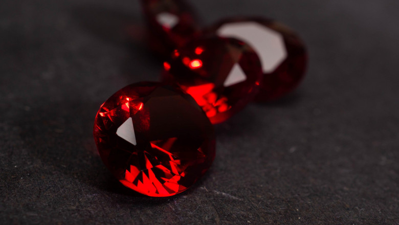Close up shoot of faceted red diamond like gems. Shoot on a black background