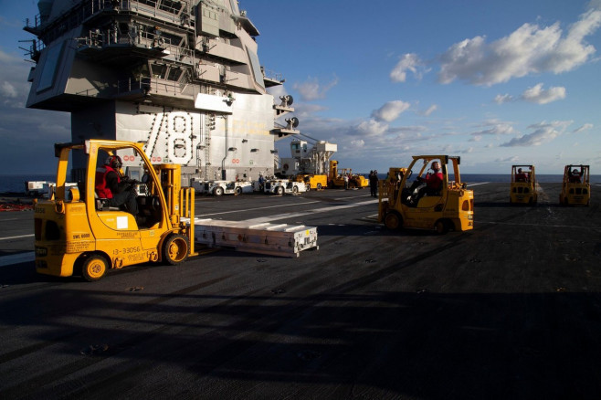 Sailors assigned to the first-in-class aircraft carrier USS Gerald R. Ford's (CVN 78) weapons department transport ammunition on the flight deck during an ammunition onload, Sept. 25, 2022. Ford is underway in Atlantic Ocean conducting carrier qualificati