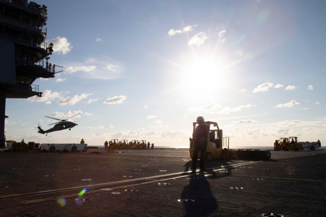 Sailors assigned to the first-in-class aircraft carrier USS Gerald R. Ford (CVN 78) and the "Tridents" of Helicopter Sea Combat Squadron (HSC) 9 conduct an ammunition onload, Sept. 25, 2022. Ford is underway in Atlantic Ocean conducting carrier qualificat