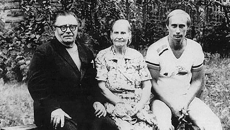 Vladimir Putin (R) pictured with his father Vladimir Putin (L) and mother Maria Putina (middle )