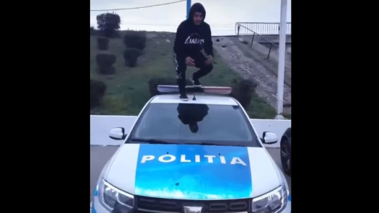 barbat pe capota unei masini de politie