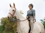 Queen Elizabth riding a horse