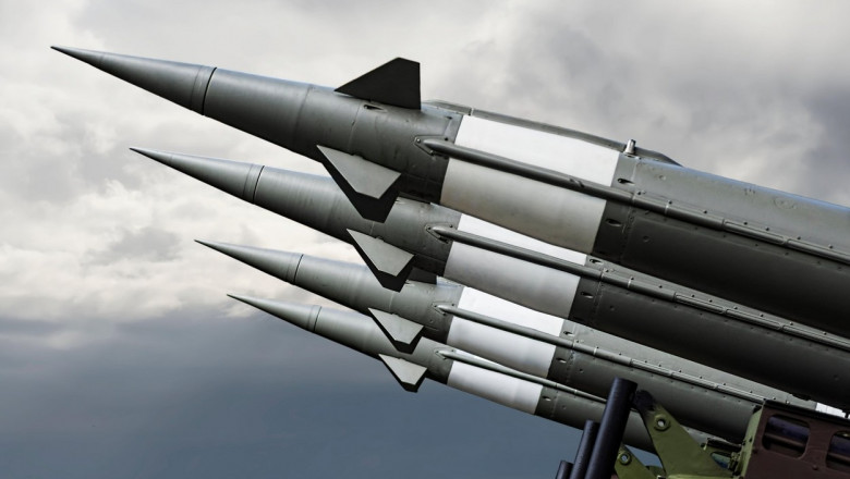 Nuclear Missiles With Warhead Aimed at Gloomy Sky. Balistic Rockets War Background.