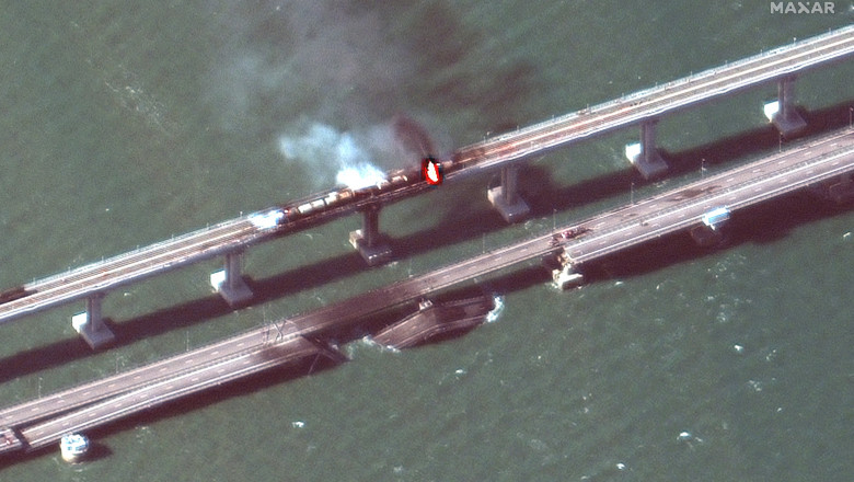 handout satellite image taken and released by Maxar Technologies on October 8, 2022, shows smoke billowing from a fire on the Crimea Bridge