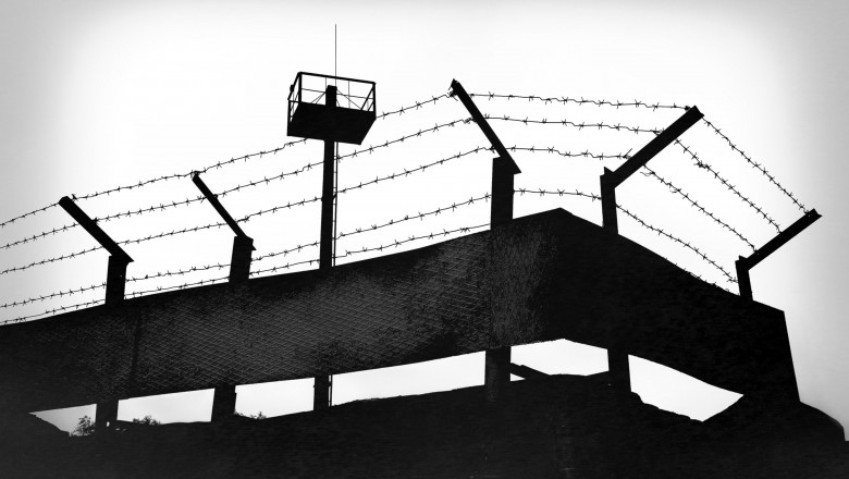 Prison fence with barbed wire, black and white grunge version