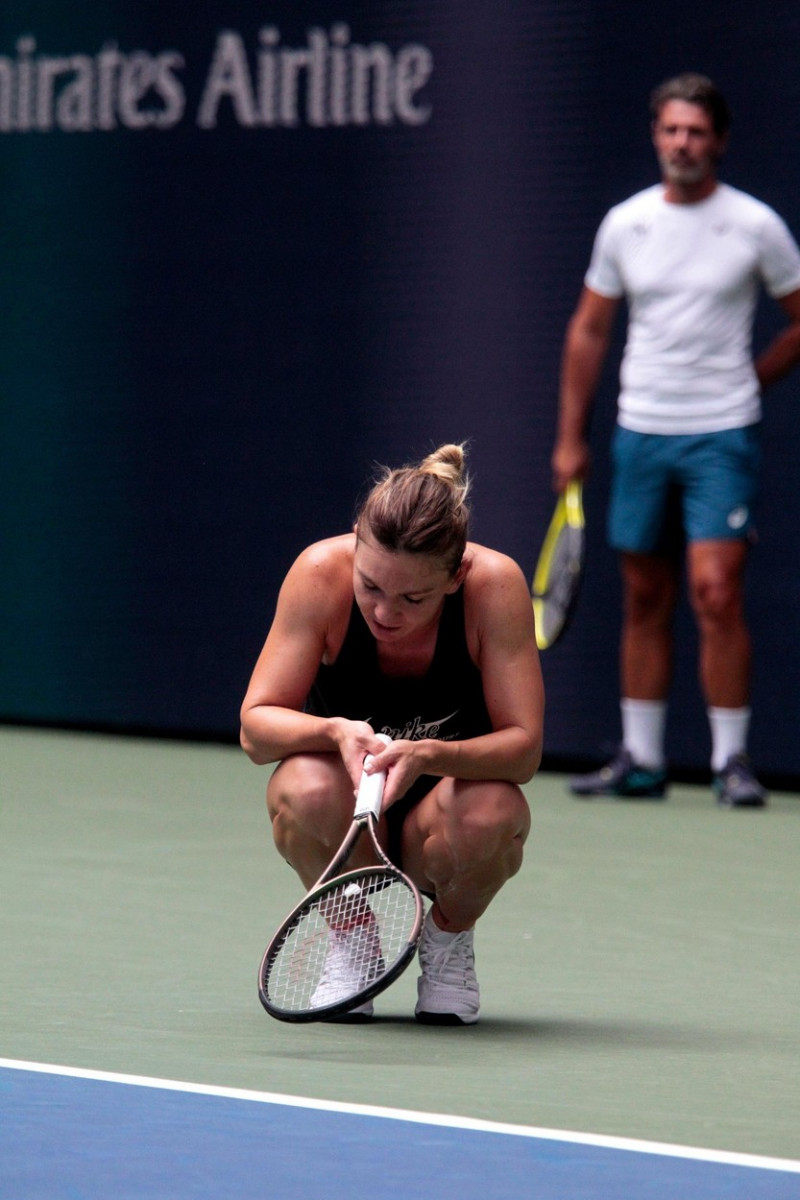 Flushing Meadows, New York, USA. 23rd Aug, 2022. Romania's Simona Halep hangs her head after a long rally while practicing for the U.S. Open today at the National Tennis Center under the watchful eye of new coach, Patrick Mouratoglou. The tournament begin