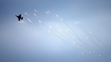 A military aircraft with combat missiles releases heat traps while flying over the Donetsk region