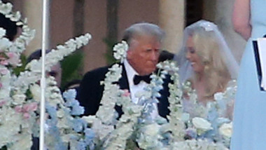 Donald Trump walks daughter Tiffany Trump down the aisle as Ivanka Trump follows behind and helps with her sisters dress as she marries Michael Boulos at Mar-A-Lago