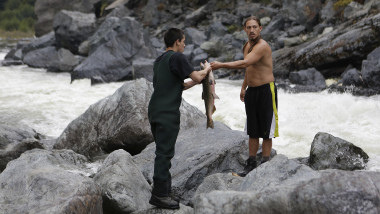 Clayton Tuttle (left) and Jerry Brink of the Karuk Indian Tribe fish for king salmon at Ishi Pishi Falls on the Klamath River