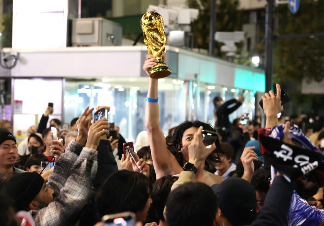 Japanese football fans celebrate Japan's victory at the FIFA World Cup