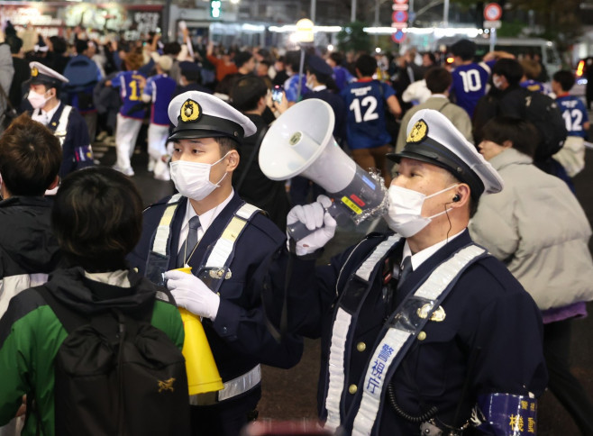 Japanese football fans celebrate Japan's victory at the FIFA World Cup