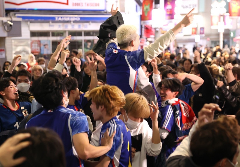 Japanese football fans celebrate Japan's victory at the FIFA World Cup