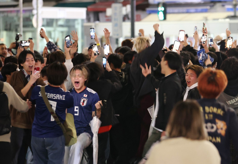 Japanese football fans celebrate Japan's victory at the FIFA World Cup