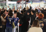 Japanese football fans celebrate Japan's victory at the FIFA World Cup