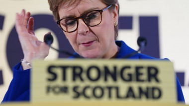 Nicola Sturgeon la o tribună a SNP, inscripționată cu textul stronger for scotland