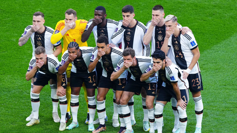 German players cover there mouths in protest as they pose for a team photo Germany v Japan