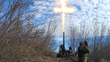militari ruși trag cu un mortier, semnul crucii făcut de focul de la gura țevii