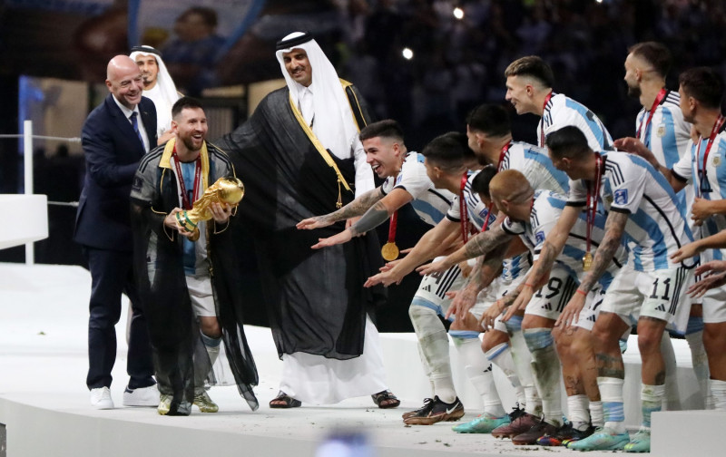 Argentina's forward Lionel Messi holds up the FIFA World Cup Trophy as he celebrates with teammates winning the Qatar 2022 World Cup final football match between Argentina and France, Doha, Qatar - 18 Dec 2022