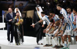 Argentina's forward Lionel Messi holds up the FIFA World Cup Trophy as he celebrates with teammates winning the Qatar 2022 World Cup final football match between Argentina and France, Doha, Qatar - 18 Dec 2022