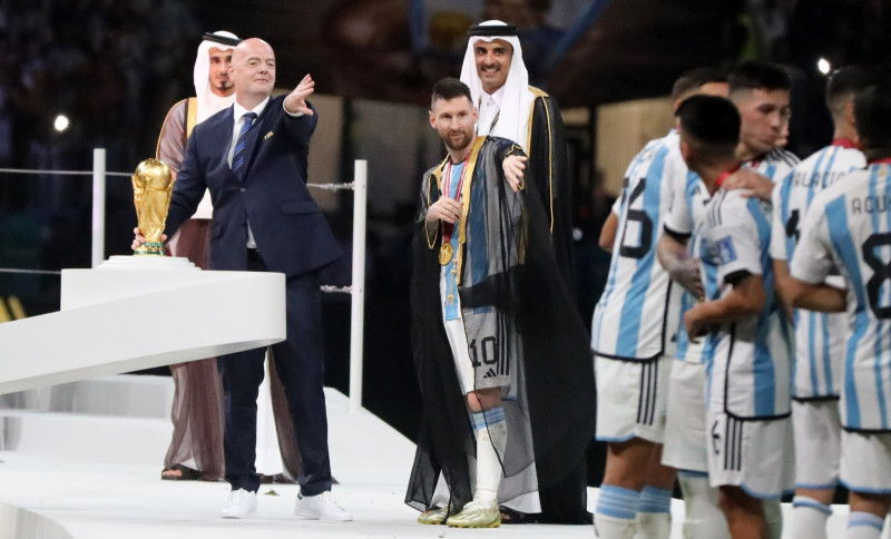 Argentina's forward Lionel Messi holds up the FIFA World Cup Trophy as he celebrates with teammates winning the Qatar 2022 World Cup final football match between Argentina and France, Doha, Qatar - 18 Dec 2022
