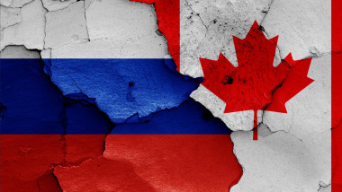 flags of Russia and Canada painted on cracked wall