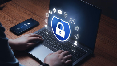 Woman checking laptop with digital security interface. Internet of things. Cybersecurity concept. Icon shield with a lock symbol.