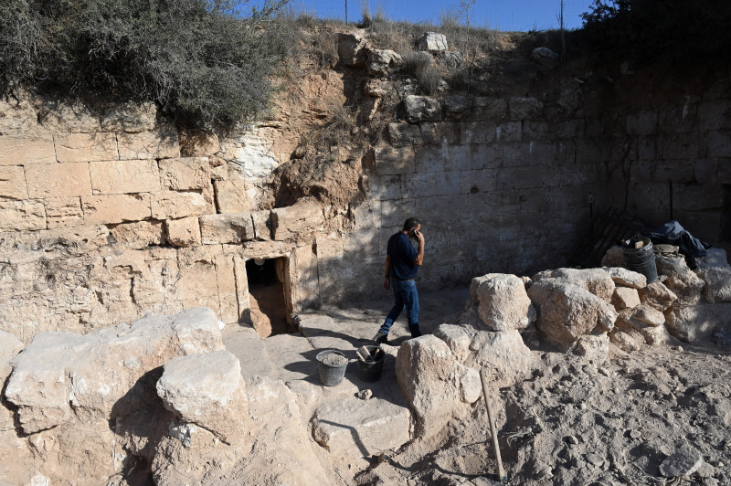 An Archeologist Walks Outside The Entrance To The Salome Cave In The Lachish Forest