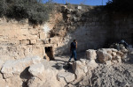 An Archeologist Walks Outside The Entrance To The Salome Cave In The Lachish Forest
