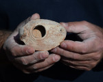 An Archeologist For The Israel Antiquities Authority Holds A Clay Lamp Found Outside The Salome Cave In The Lachish Forest