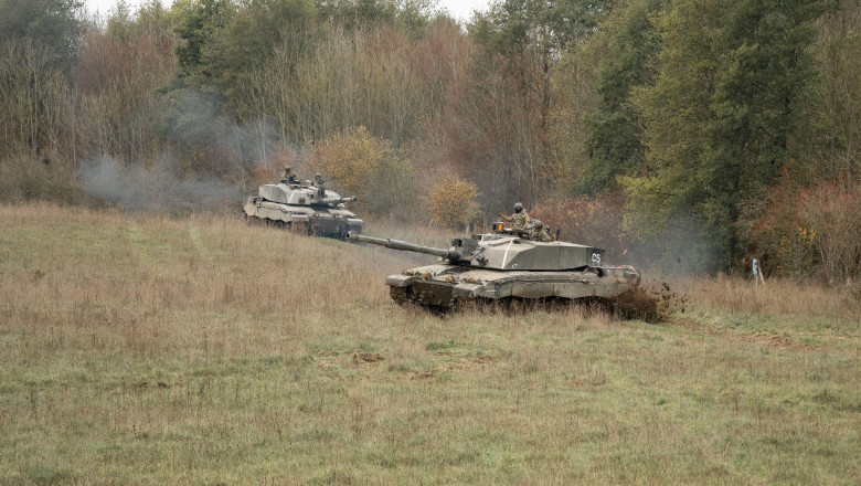 close-up of two British army FV4034 Challenger 2 ii main battle tanks in action, manoeuvering on a military exercise, Wiltshire UK
