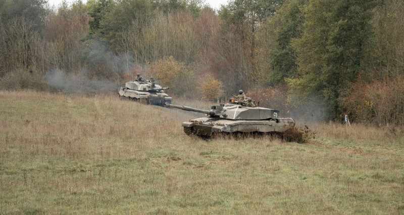 close-up of two British army FV4034 Challenger 2 ii main battle tanks in action, manoeuvering on a military exercise, Wiltshire UK