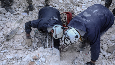 Personnel and civilians conduct search and rescue operations in Idlib, Syria after 7.7 and 7.6 magnitude earthquakes