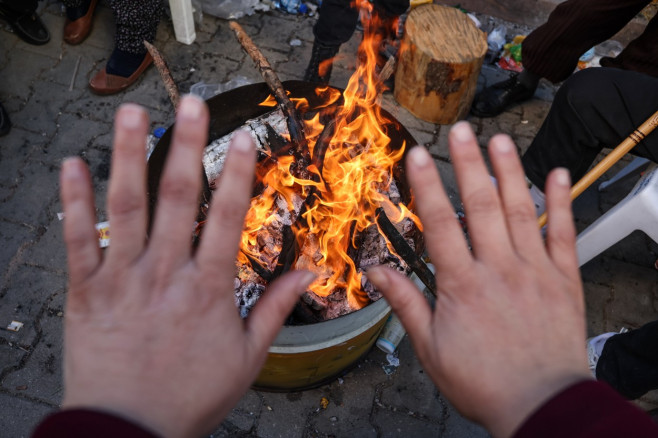 People wait in cold as rescues continue in Adana following deadly earthquakes