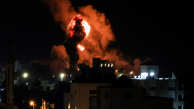 Fire and smoke rise above buildings in Gaza City as Israel launched air strikes on the Palestinian enclave early on February 13