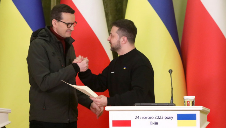 Premierul polonez Mateusz Morawiecki îi strânge mâna președintelui Ucrainei Volodimir Zelenski în timpul unei vizite la Kiev pe 24 februarie 2023.
