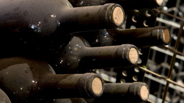 Sticle de vin acoperite de praf într-o cramă din Spania.