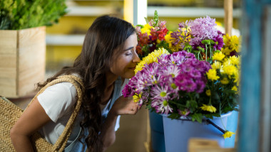 Woman smelling a bunch of flowers