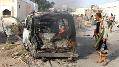 A Yemeni man looks at a burning vehicle following a reported suicide car bombing in Huta, the capital of the southern province of Lahj, a bastion of Al-Qaeda jihadists