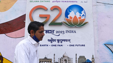A man walks past a grafitti depicting the logo of G20 Summit in New Delhi,