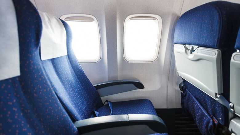 blue seats in economy class passenger section of airplane