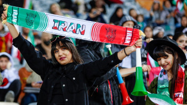 A woman fan cheers for Iran's national team during the friendly football match between Iran and Russia