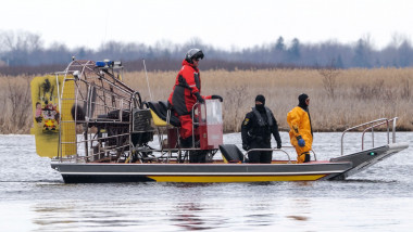 Searchers look for victims Friday, March 31, 2023 after a boat capsized and left six people dead and one infant missing in Akwesasne, Que