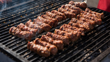 Traditional Romanian food, barbecue with grilled meat rolls called mititei or mici
