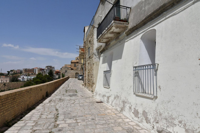 A narrow street among the old houses of Irsina in Basilicata, region in southern Italy.