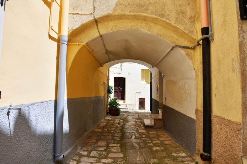 A narrow street among the old houses of Irsina in Basilicata, region in southern Italy.