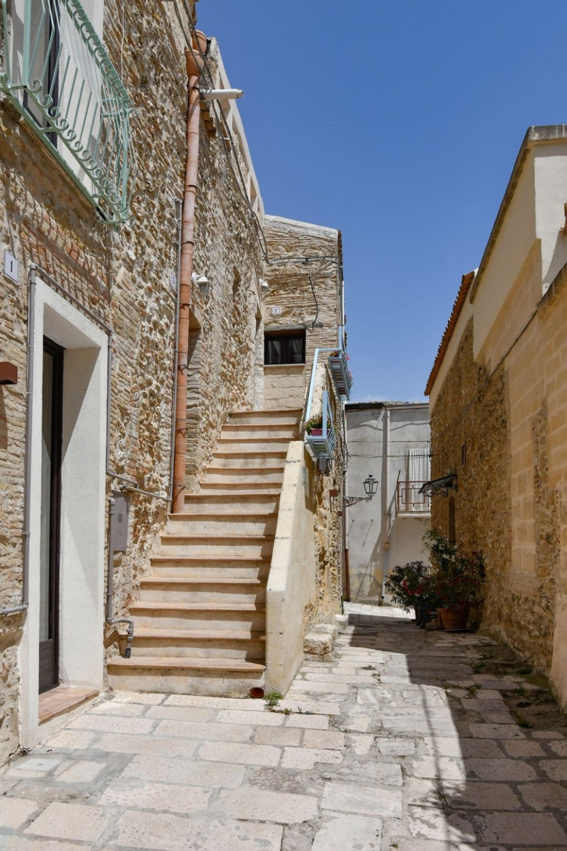 A narrow street among the old houses of Irsina in Basilicata, region in southern Italy.