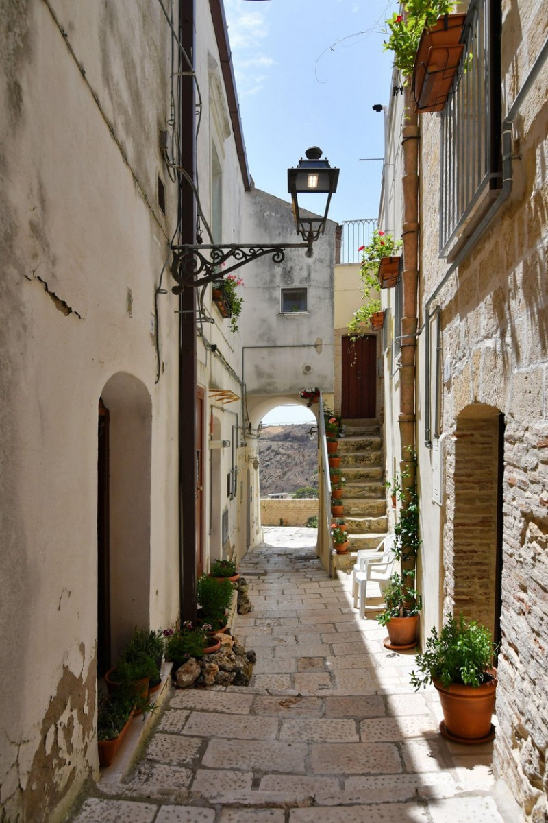 A narrow street among the old houses of Irsina in Basilicata, region in southern Italy.