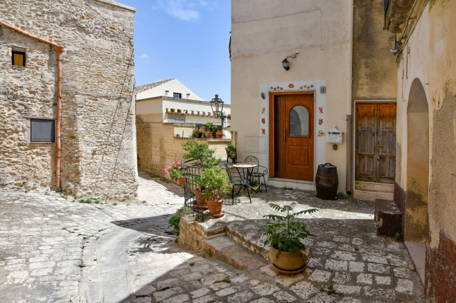A narrow street among the old houses of Irsina in Basilicata, region in southern Italy.