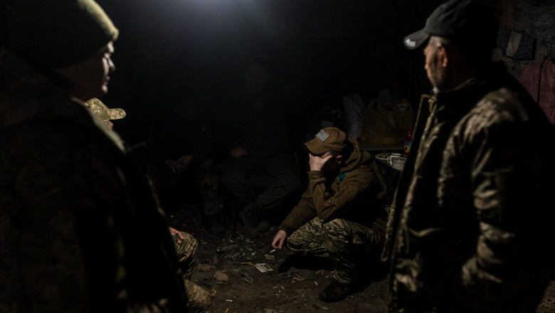 Ukrainian soldiers of the 57th Brigade take shelter from Russian shelling at a cellar near the frontline in the direction of Bakhmut
